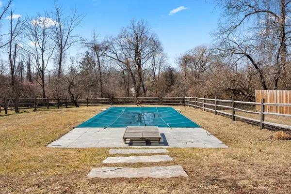 a view of backyard with swimming pool