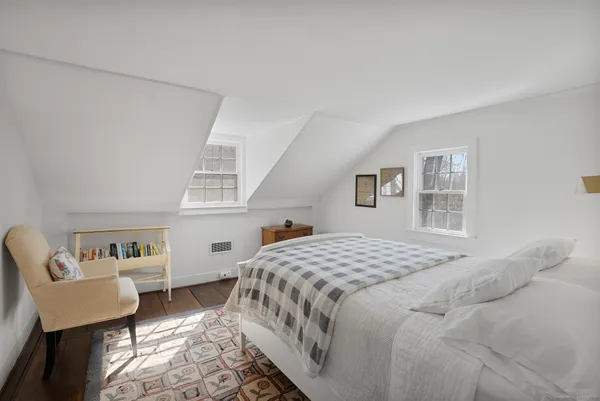 a bedroom with a bed a couch and dresser