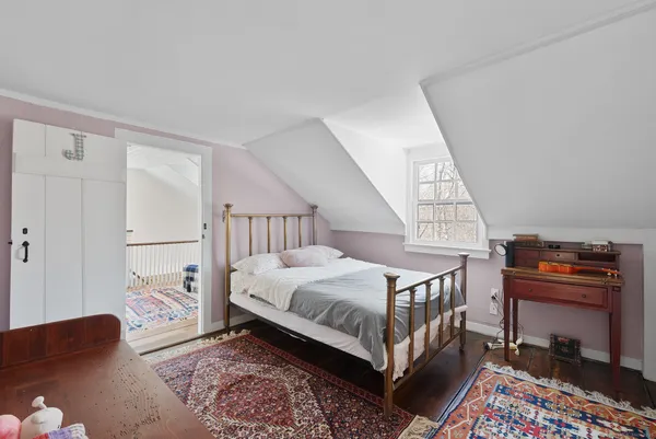 a bedroom with bed and a window
