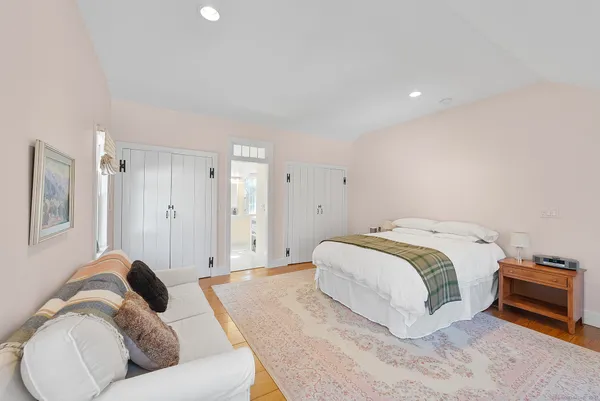 a spacious bedroom with a bed and a couch