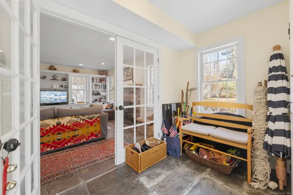 a bedroom with furniture and a rug