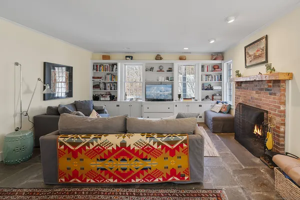 a living room with furniture and a fireplace