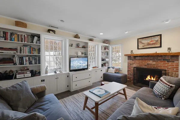 a living room with furniture fireplace and flat screen tv