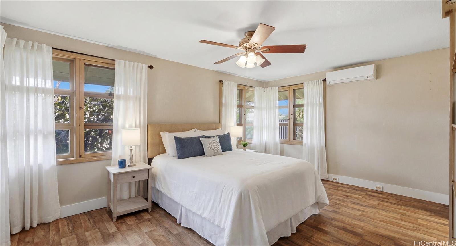 91-779 Fort Weaver Road Ewa Beach, HI 96706 - Photo 14 of 25 Bright main-level bedroom suite featuring split AC, a ceiling fan, and a private en-suite bath.