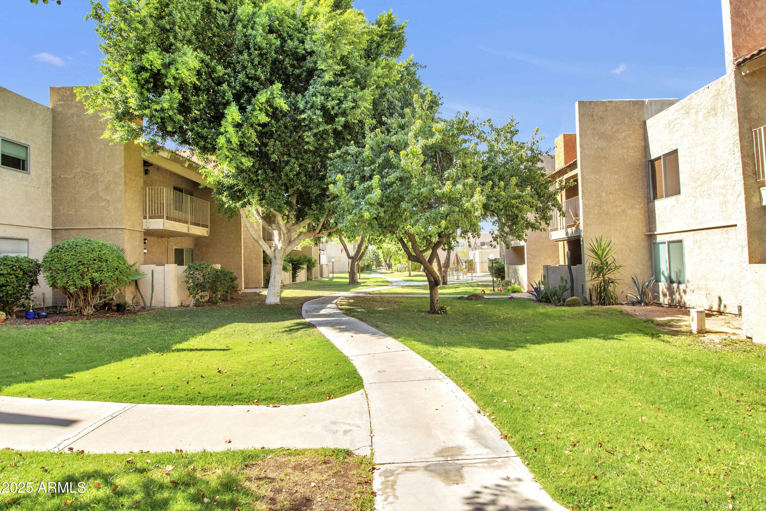 5525 East Thomas Road, Unit M16 Phoenix, AZ 85018 - Photo 20 of 27 a front view of a house with a yard