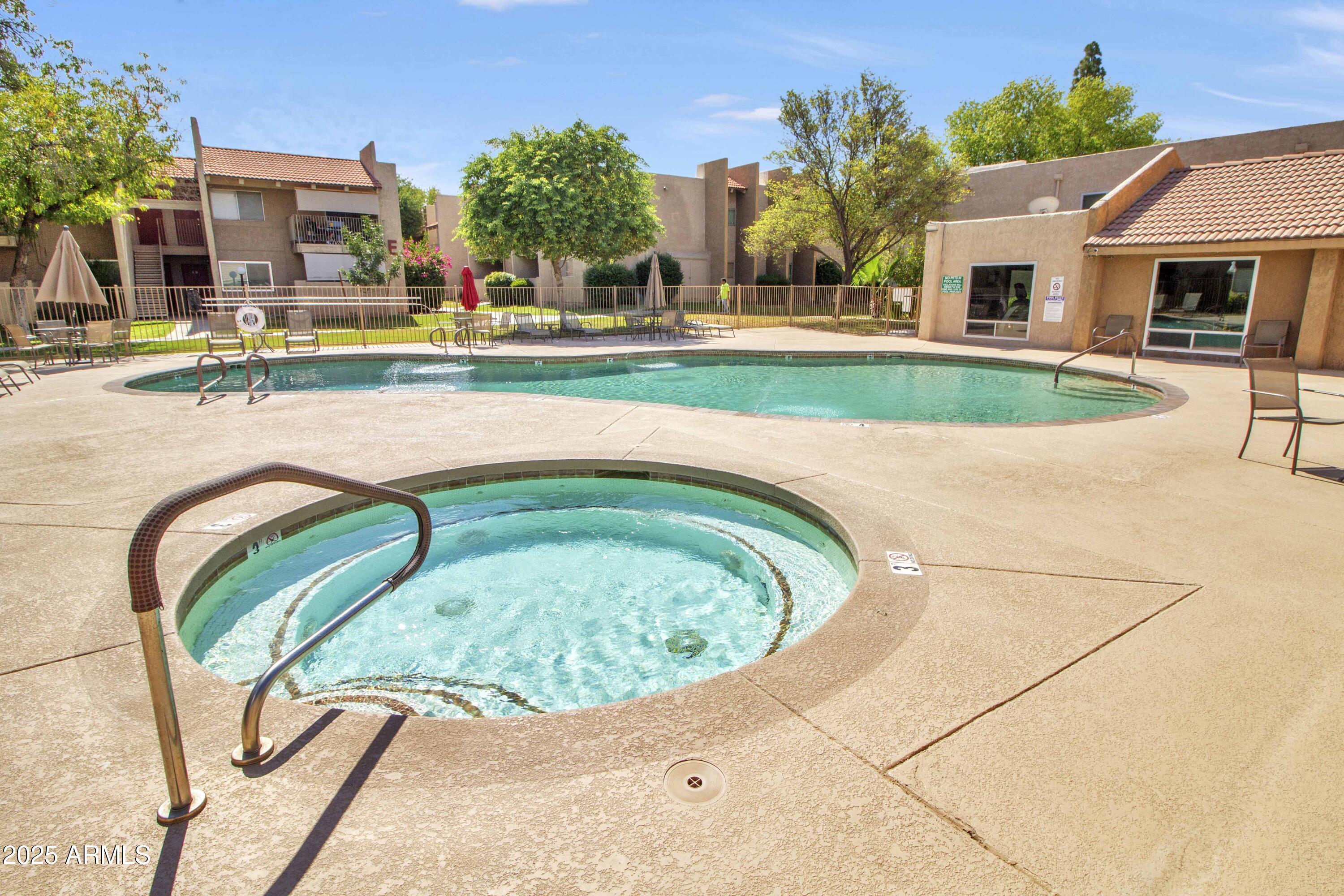 5525 East Thomas Road, Unit M16 Phoenix, AZ 85018 - Photo 21 of 27 a view of swimming pool with outdoor seating and house in the background