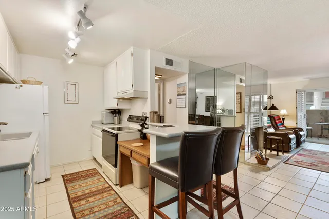 a kitchen with stainless steel appliances kitchen island granite countertop a sink and cabinets