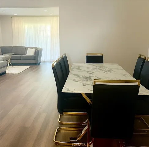 a room with a table chairs and a window