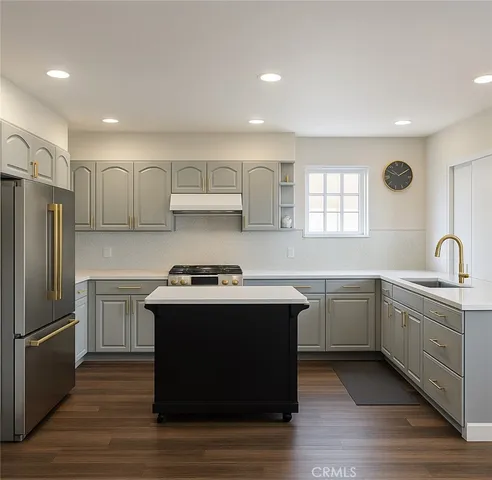 a kitchen with stainless steel appliances granite countertop a sink stove and refrigerator