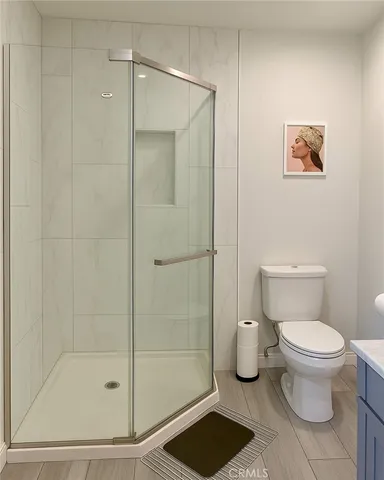 a bathroom with a toilet and a shower