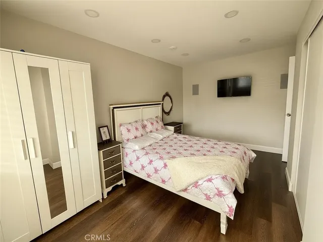 a bedroom with a bed and a mirror