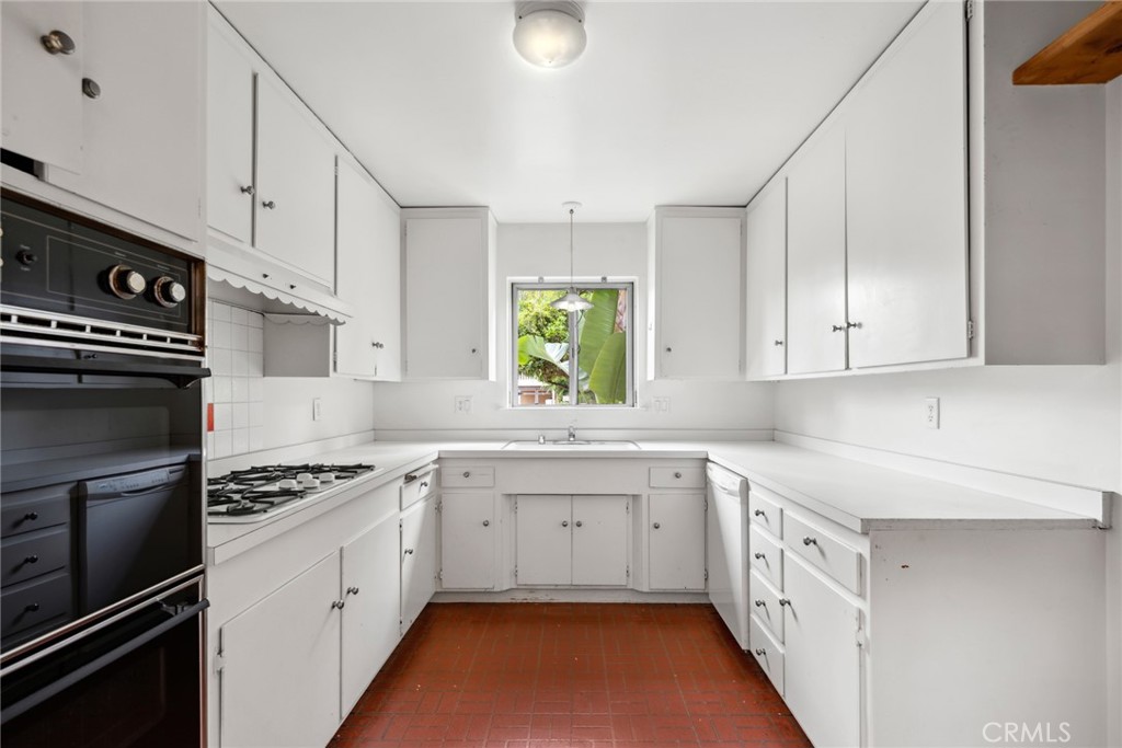 505 Graceland Drive Laguna Beach, CA 92651 - Photo 10 of 29 a kitchen with granite countertop a sink stainless steel appliances and cabinets