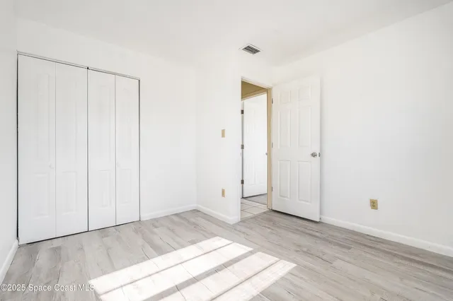a view of a room with wooden floor