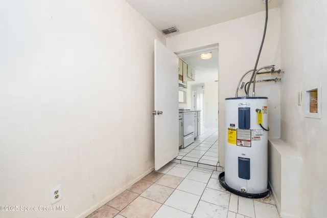a hallway with a refrigerator and mirror