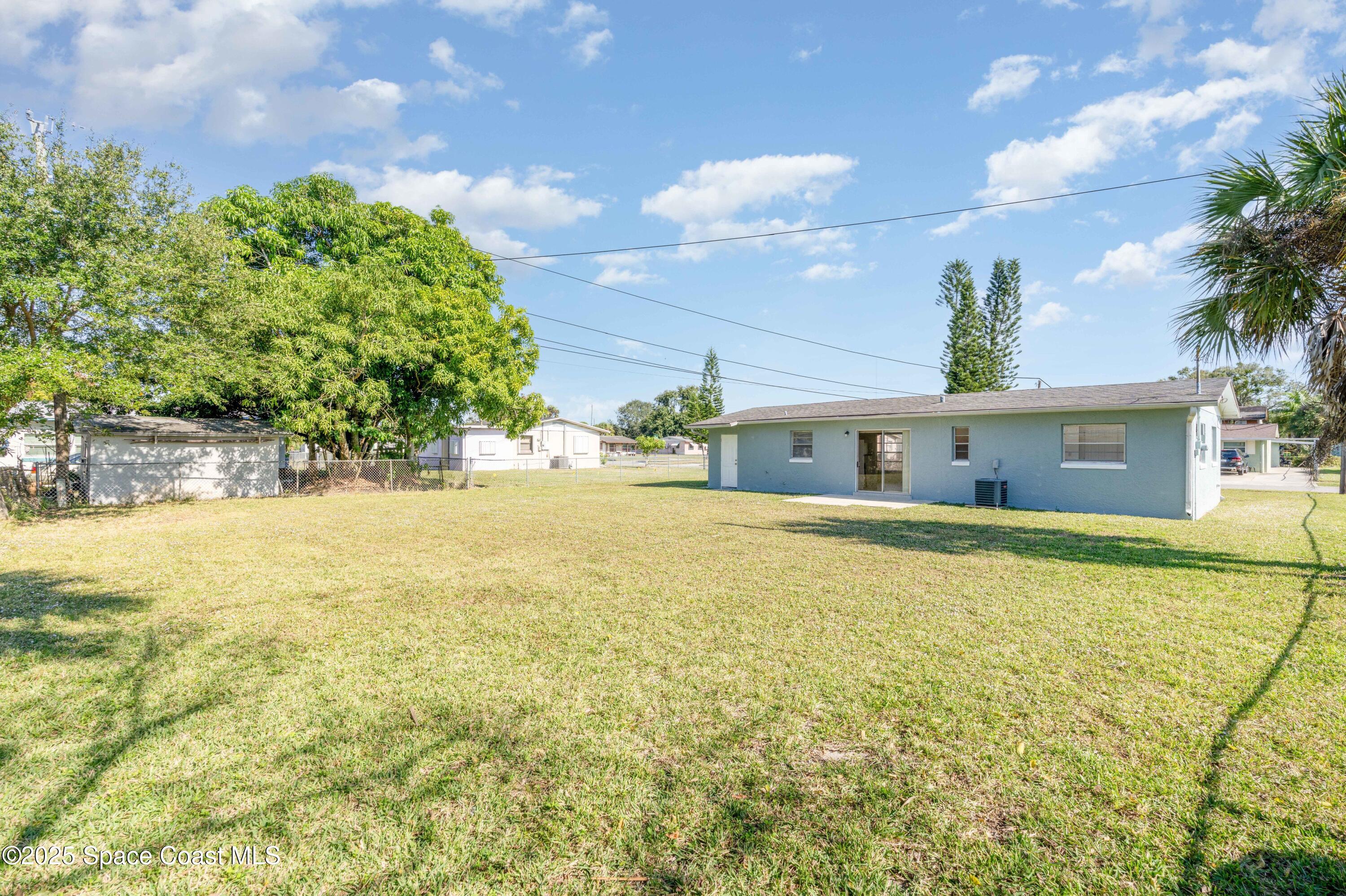 557 Cox Street Cocoa, FL 32926 - Photo 18 of 20 a front view of house with yard