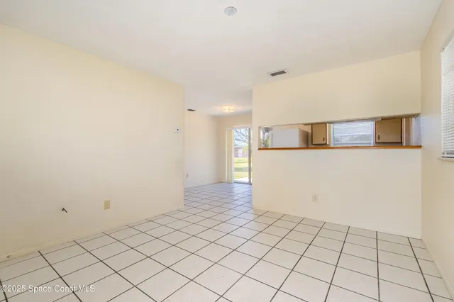 a view of a kitchen with white cabinets