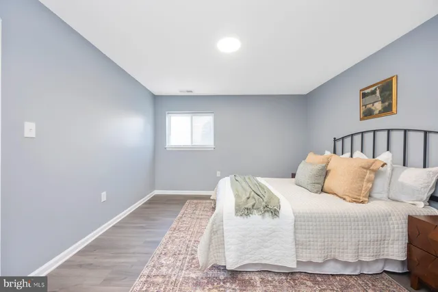 a bedroom with a bed and a night stand