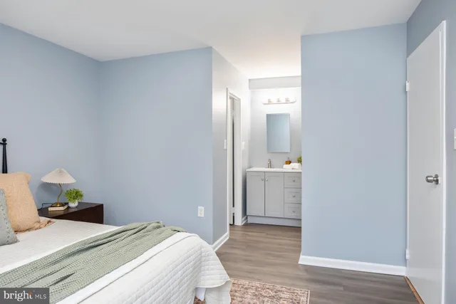 a bedroom with a bed and wooden floor
