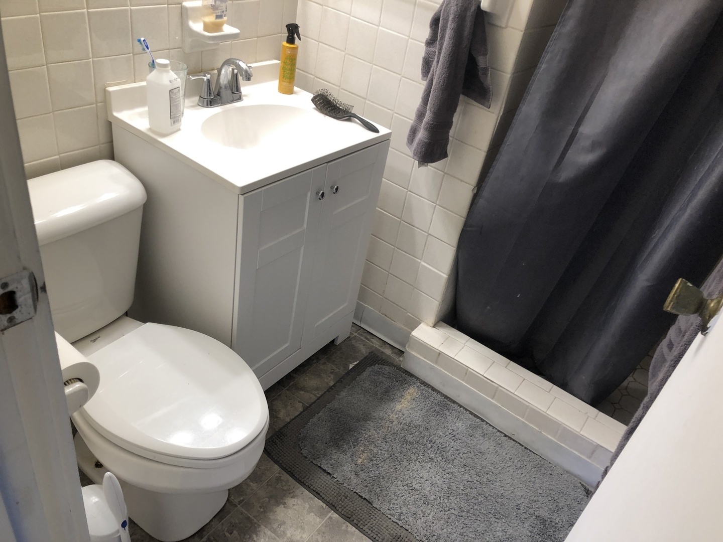 1011 West Church Street Champaign, IL 61821 - Photo 2 of 20 a white toilet sitting next to a white sink