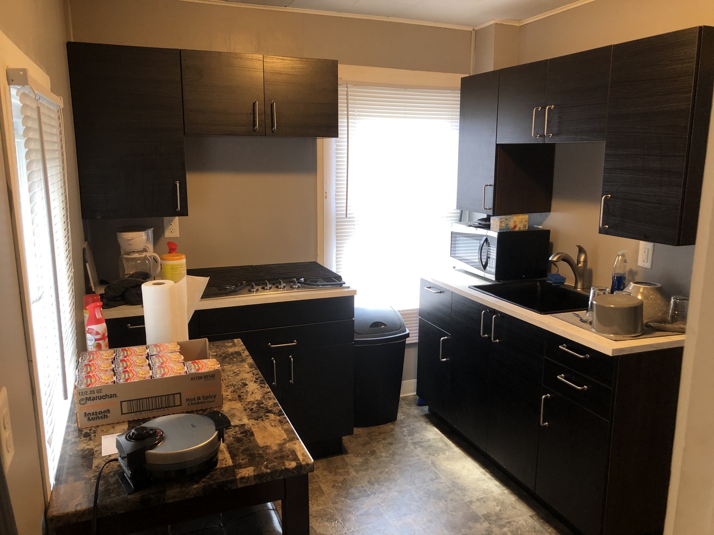 1011 West Church Street Champaign, IL 61821 - Photo 3 of 20 a kitchen with a sink and a stove top oven