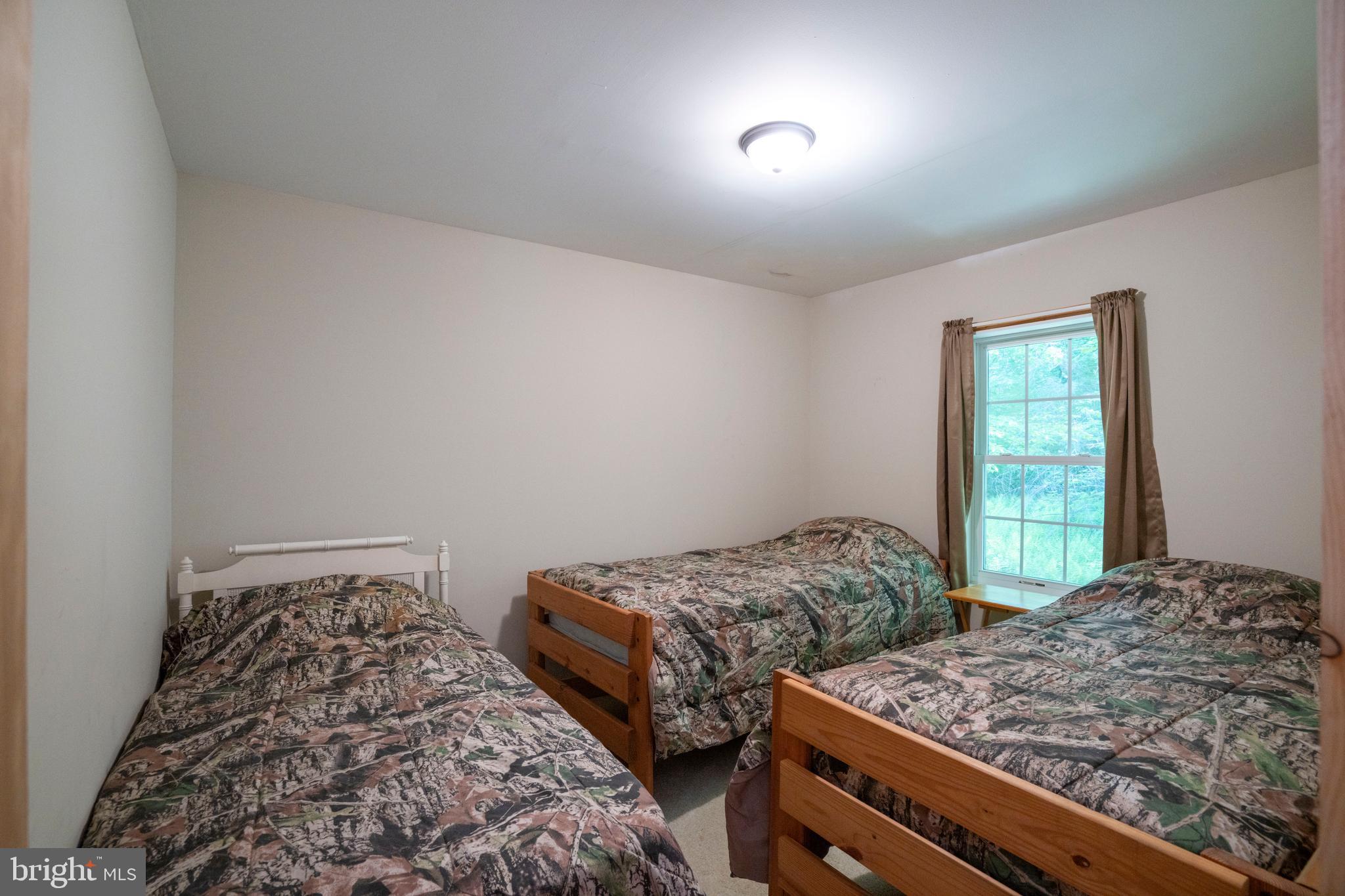385 Elk Creek Road Aaronsburg, PA 16820 - Photo 47 of 71 a bedroom with two beds and a window