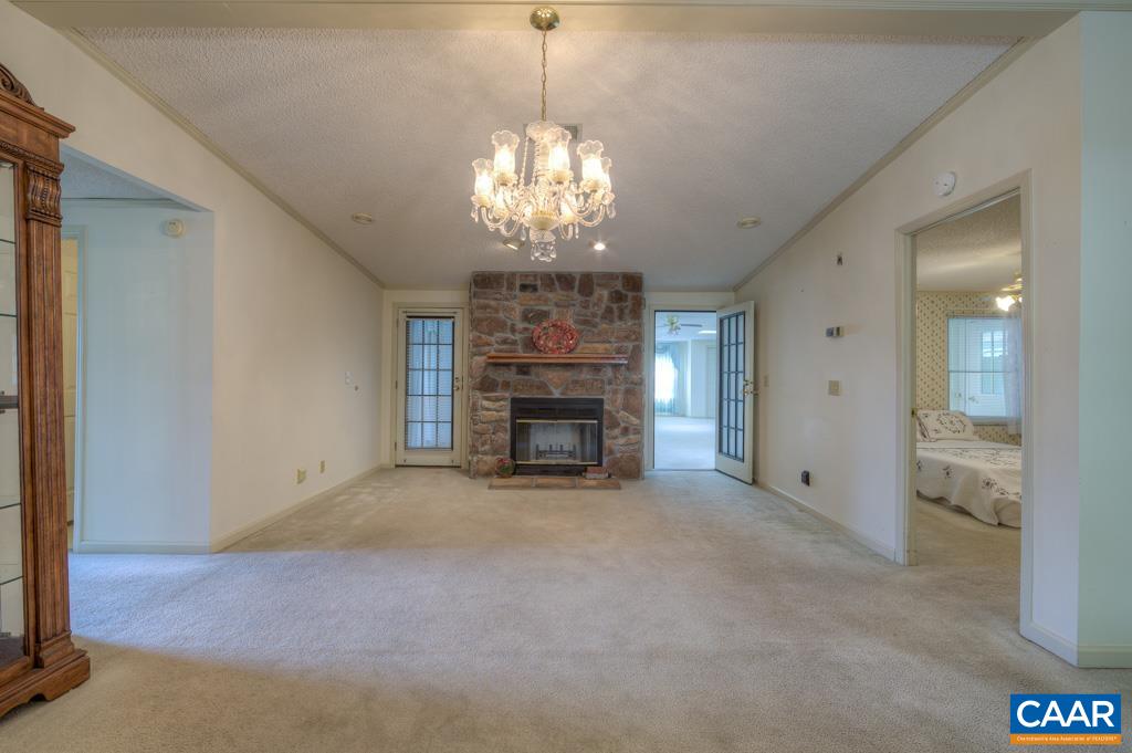 11 Gladiola Road Ruckersville, VA 22968 - Photo 8 of 28 a view of a hallway with a chandelier and fireplace