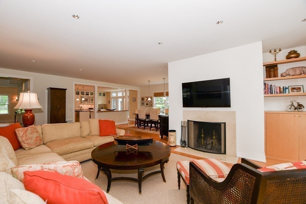 594 Point Road Marion, MA 02738 - Photo 14 of 37 a living room with furniture a flat screen tv and a fireplace