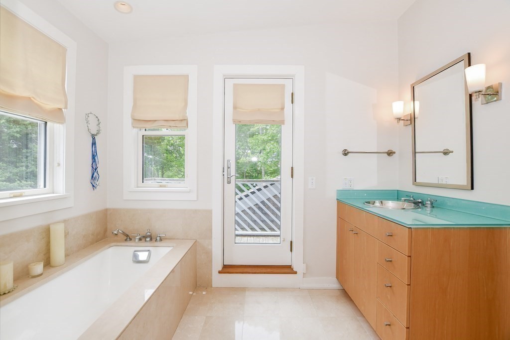594 Point Road Marion, MA 02738 - Photo 26 of 37 a en suite bathroom with a granite countertop tub and a sink