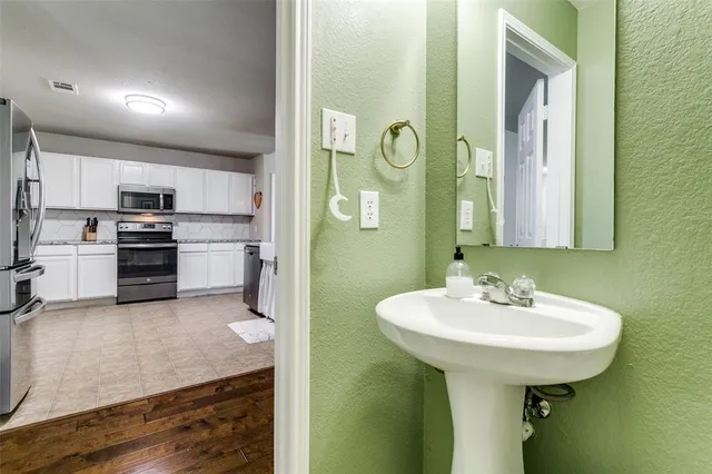 a kitchen with granite countertop a refrigerator stove and sink
