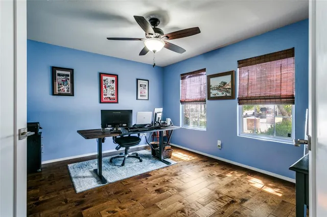 a work room with furniture wooden floor and a window