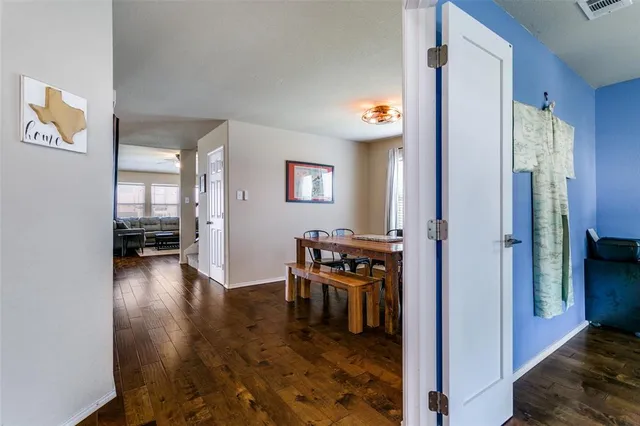 a view of a hallway to a livingroom with furniture