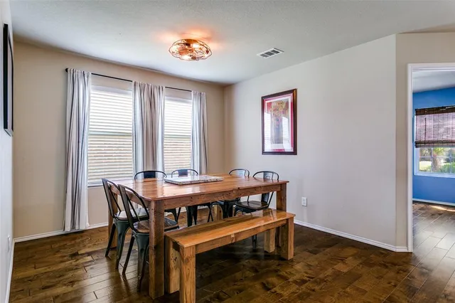 a view of a dining room with furniture and window