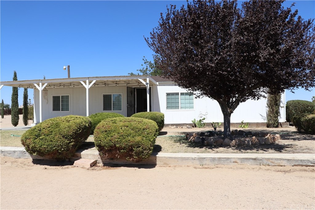 33292 Delaney Road Barstow, CA 92311 - Photo 1 of 1 a view of a white house with a large tree