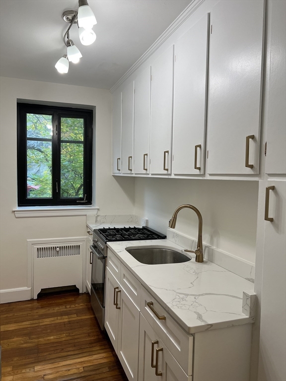 65 Strathmore Road, Unit 31 Boston, MA 02135 - Photo 3 of 7 a kitchen with a sink cabinets and window