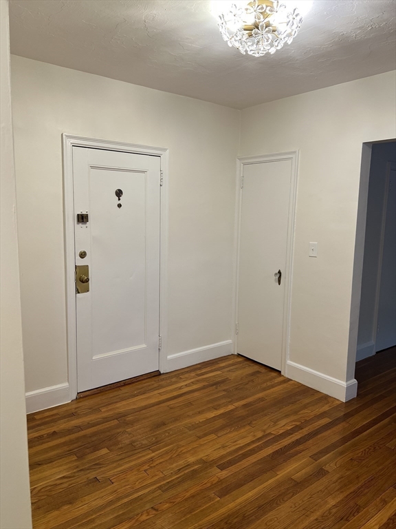 65 Strathmore Road, Unit 31 Boston, MA 02135 - Photo 5 of 7 a view of an empty room with wooden floor