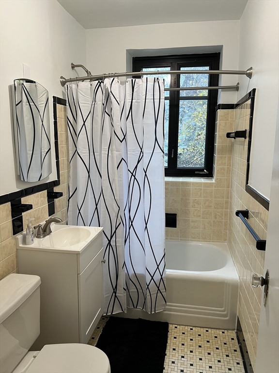 65 Strathmore Road, Unit 31 Boston, MA 02135 - Photo 6 of 7 a bathroom with a sink a toilet and a bathtub
