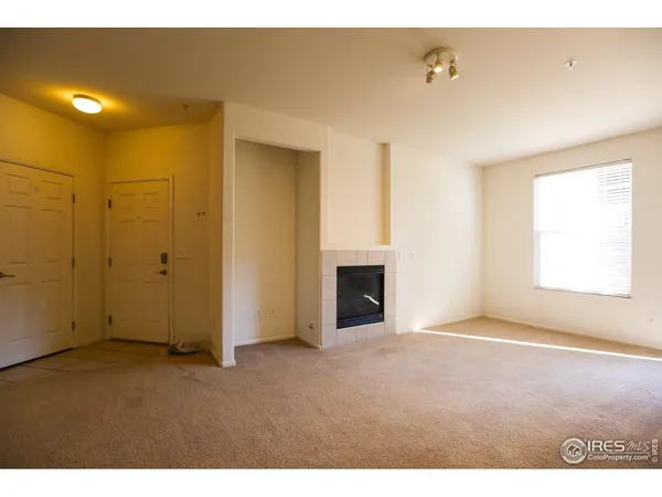 a view of an empty room with a fireplace