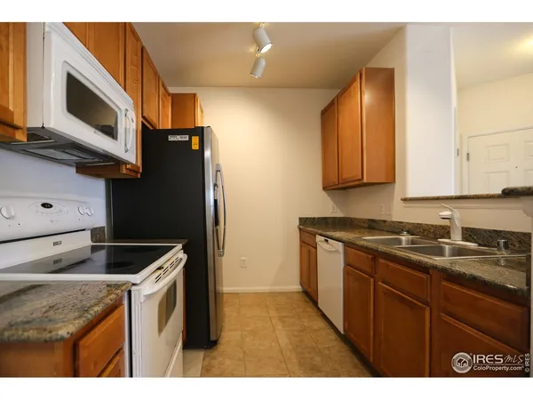 a kitchen with a sink and steel appliances