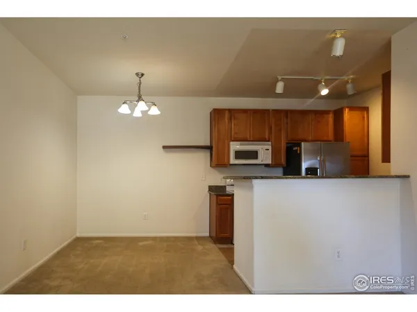 a view of kitchen with kitchen island microwave and stove