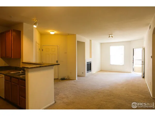 a view of a livingroom with kitchen appliances