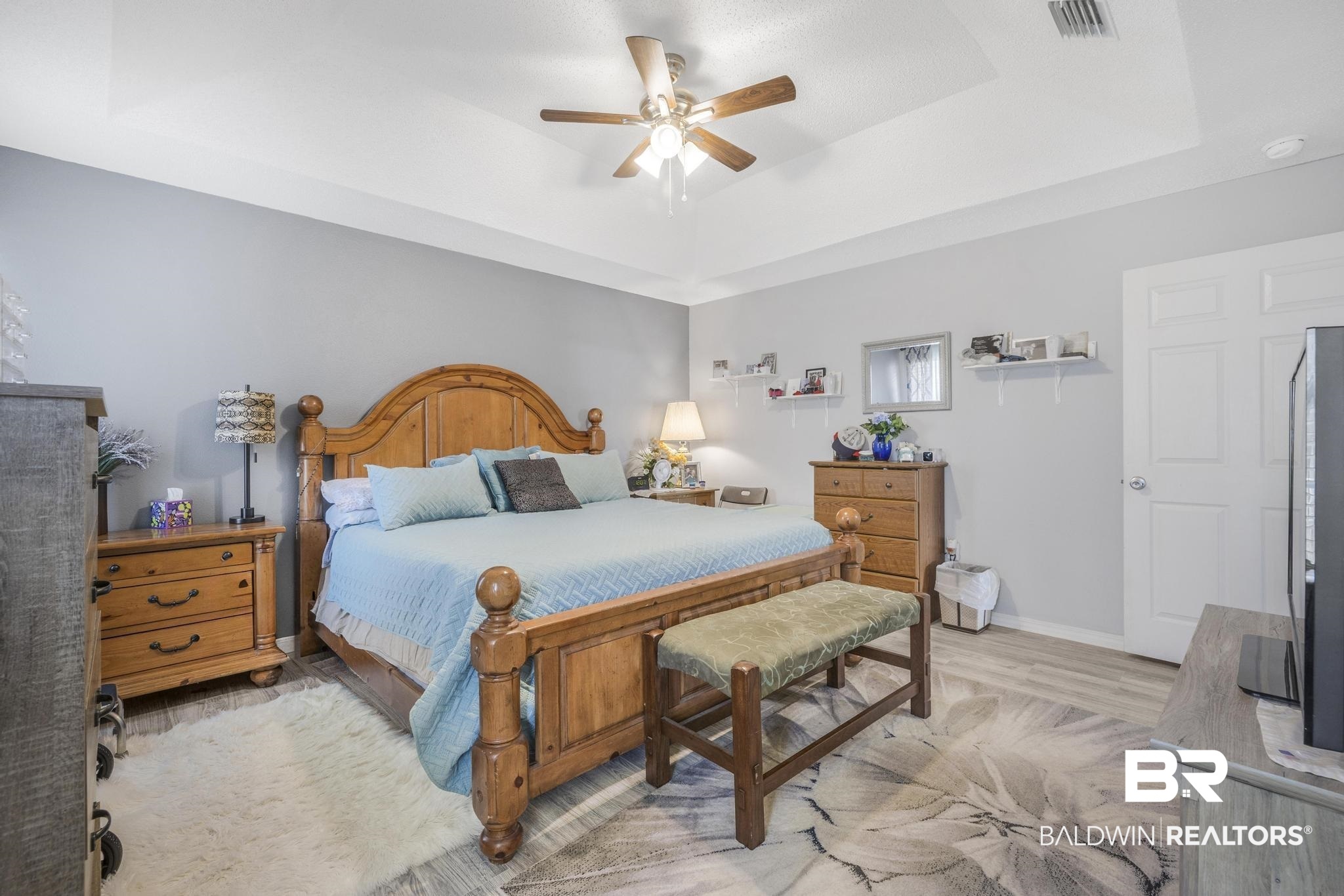 16545 Cold Mill Loop Foley, AL 36535 - Photo 17 of 48 Bedroom with baseboards, a raised ceiling, light wood finished floors, ceiling fan, and visible vents