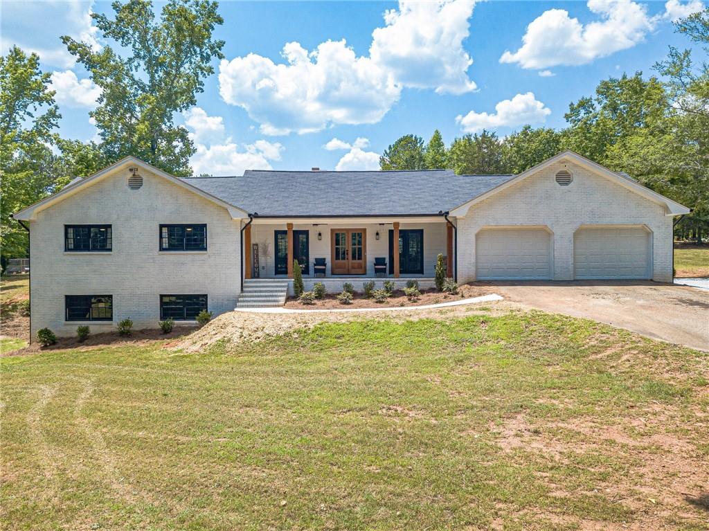 1880 Wall Road Monroe, GA 30656 - Photo 1 of 1 a house view with swimming pool and trees in the background