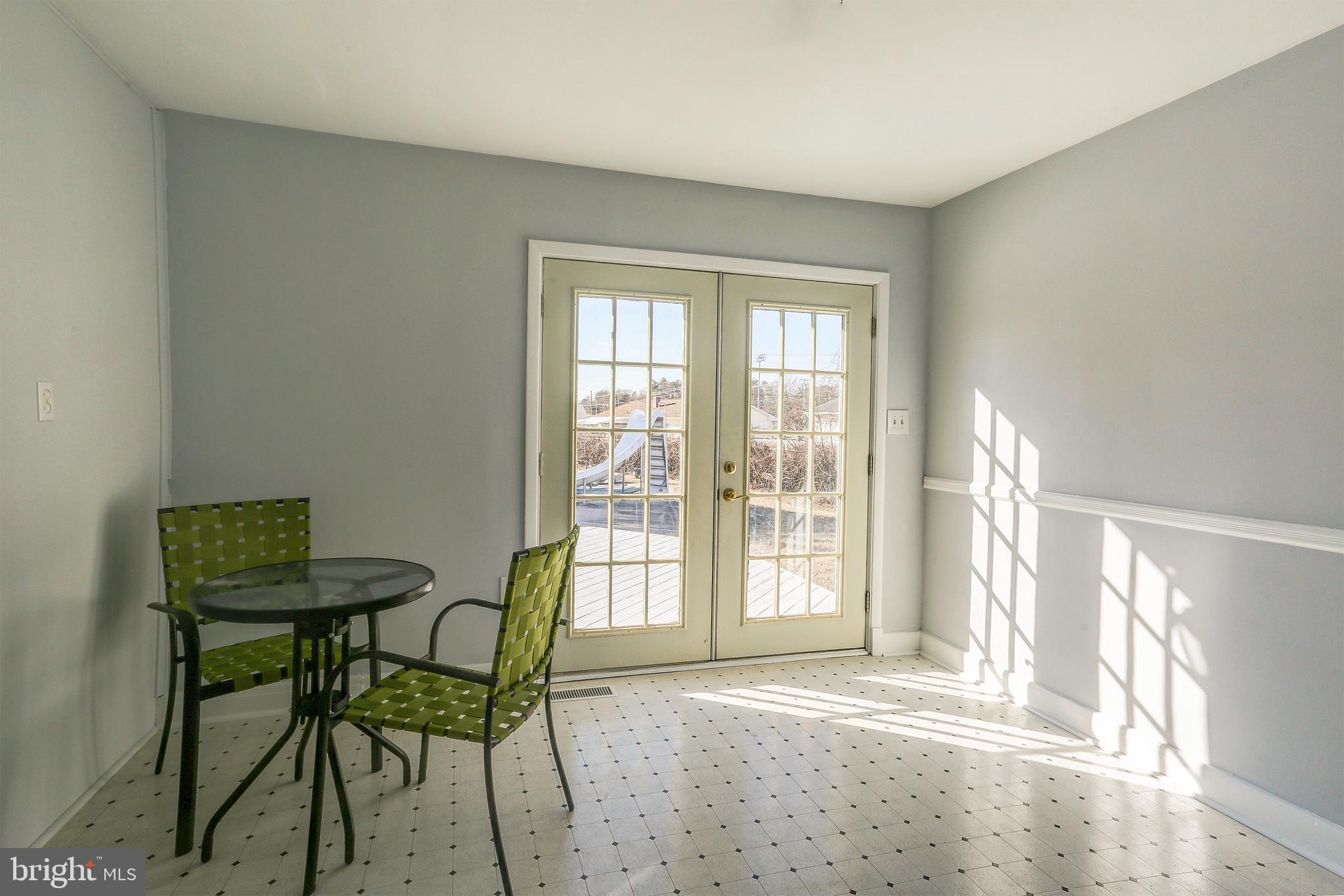 1201 Meadow View Road Pasadena, MD 21122 - Photo 12 of 34 Sun room leading to deck and pool.