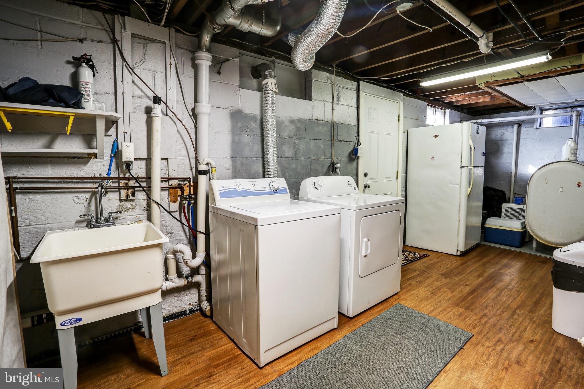 1201 Meadow View Road Pasadena, MD 21122 - Photo 24 of 34 Lower level washer and dryer and refrigerator.