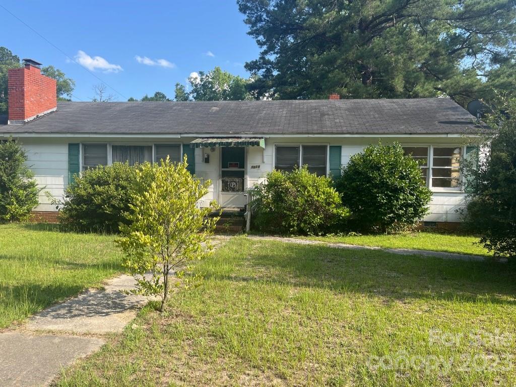 1510 East Washington Street Rockingham, NC 28379 - Photo 1 of 1 a front view of a house with a garden