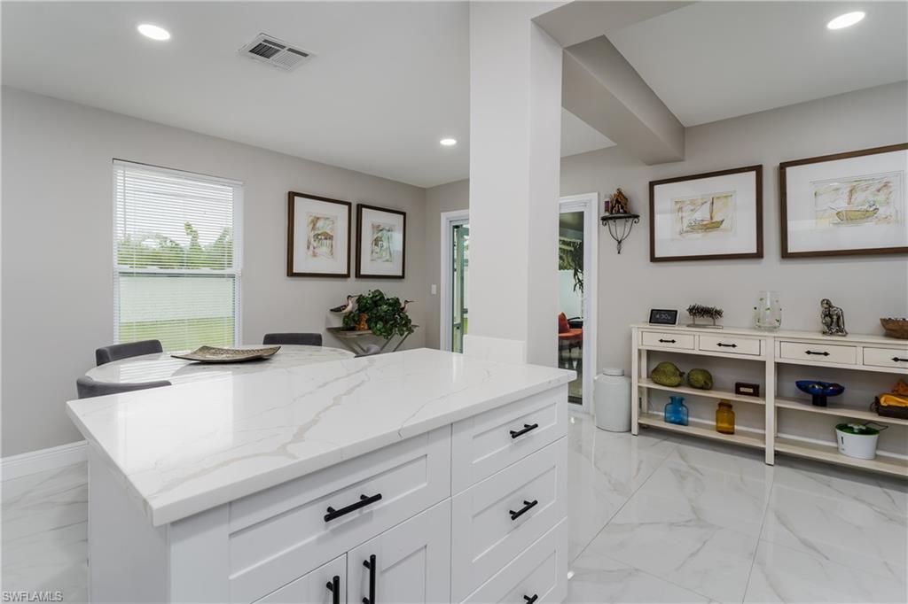 5170 19th Court Southwest Naples, FL 34116 - Photo 11 of 32 a kitchen with stainless steel appliances a stove and cabinets