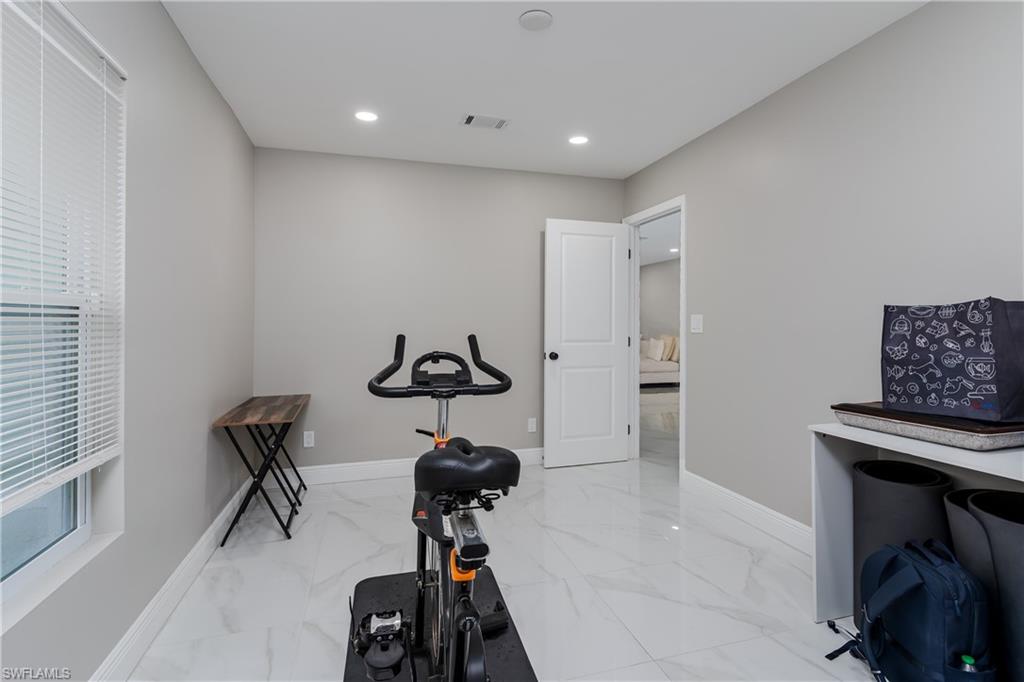 5170 19th Court Southwest Naples, FL 34116 - Photo 20 of 32 a view of a room with gym equipment