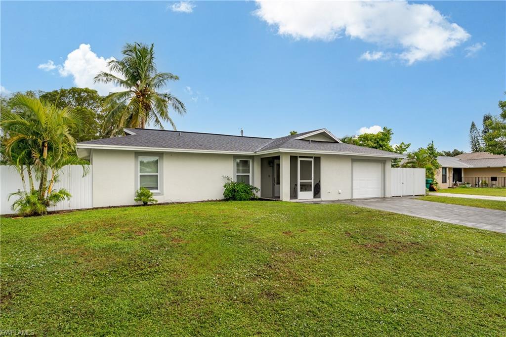 5170 19th Court Southwest Naples, FL 34116 - Photo 27 of 32 a front view of a house with a garden and yard