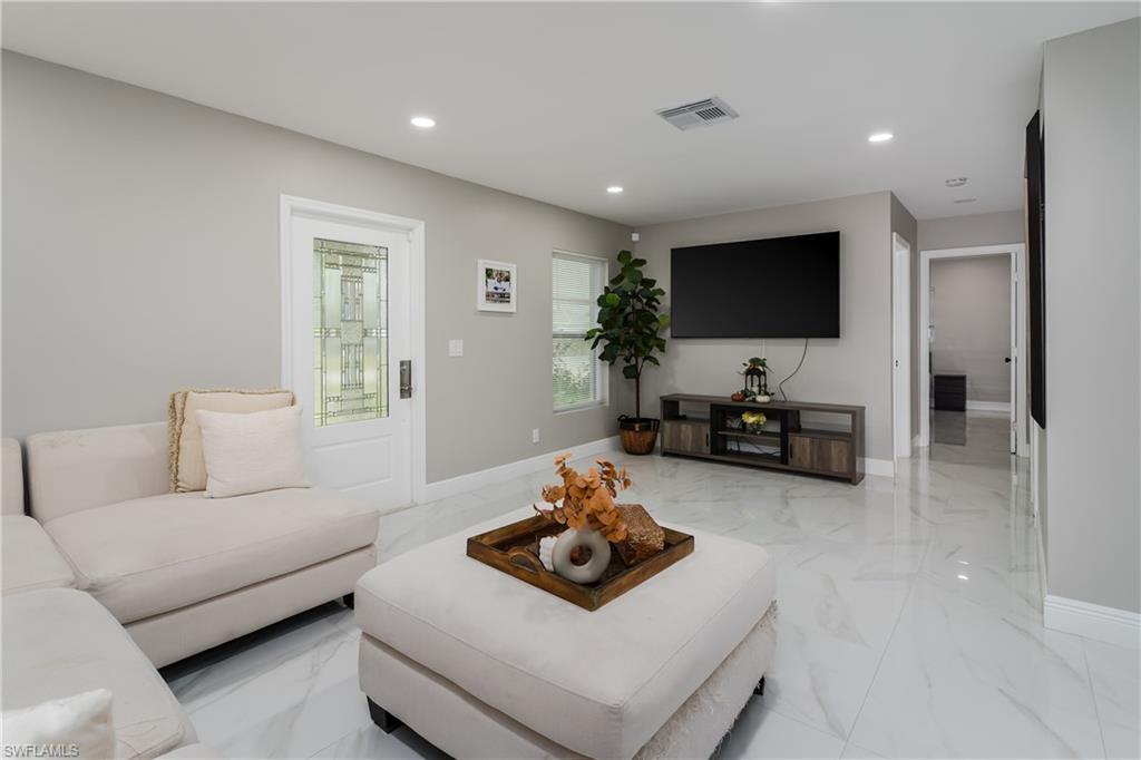 5170 19th Court Southwest Naples, FL 34116 - Photo 3 of 32 a living room with furniture and a flat screen tv