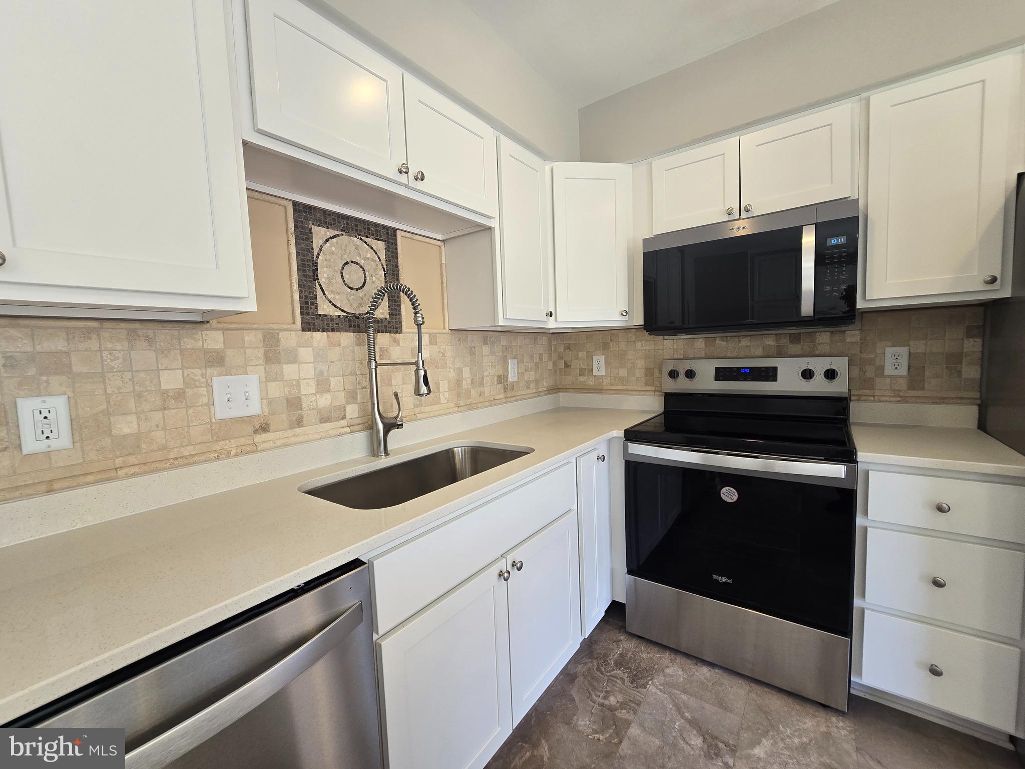 1248 Steed Street Ranson, WV 25438 - Photo 11 of 42 a kitchen with cabinets appliances a sink and a counter top space